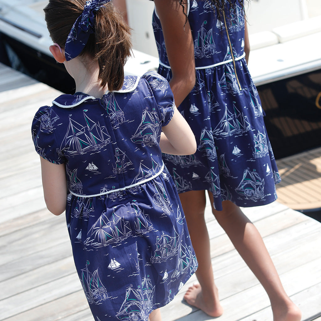 Two girls walking on dock in Commodore Print dresses